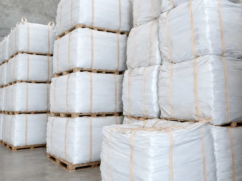 Big bags stacked on pallets in a warehouse